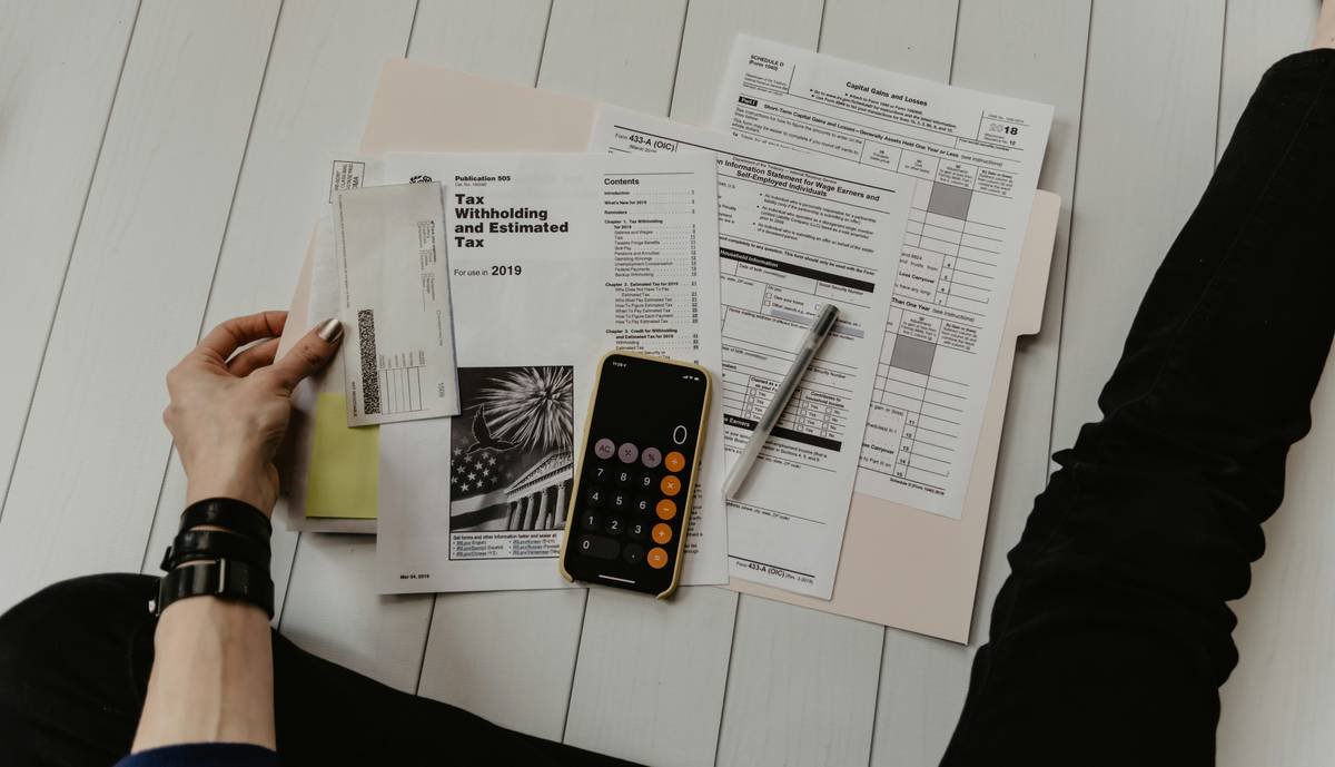 Homeowner reviewing documents to accurately track budgeting remediation costs